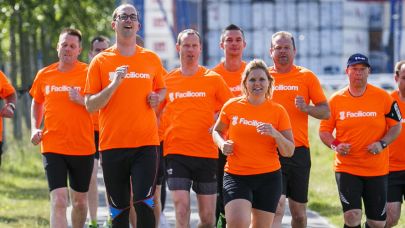 Hardlopende collega's in oranje t-shirts