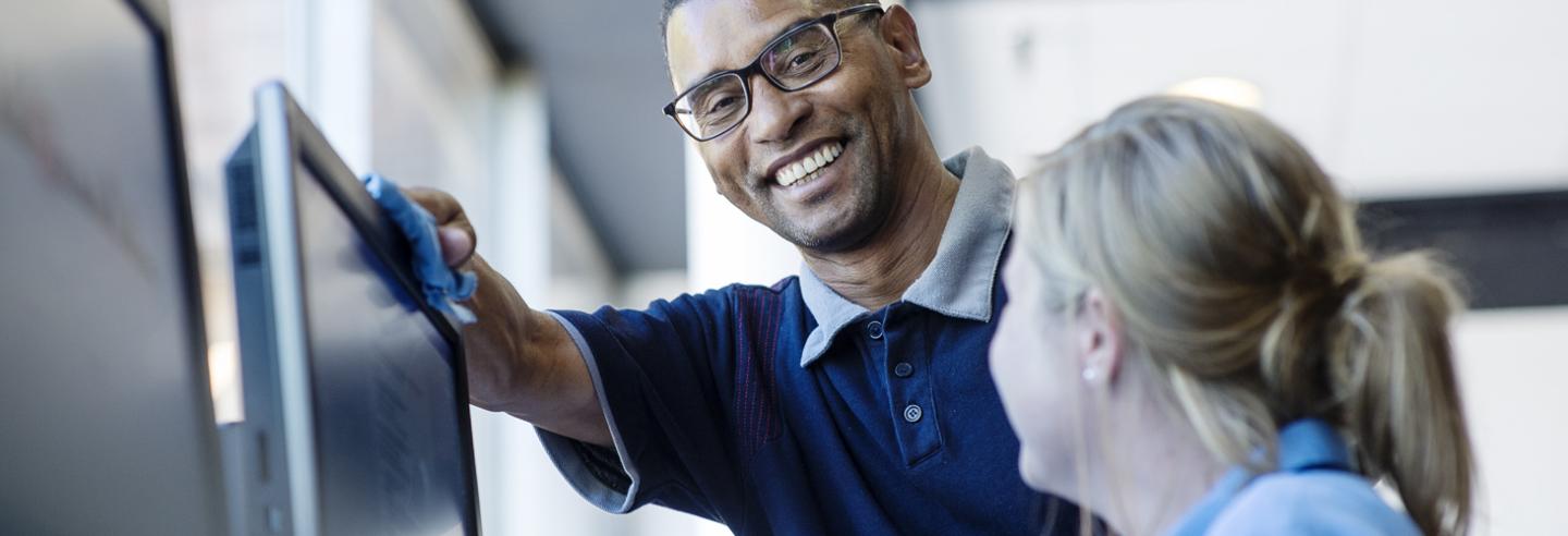 Plezierig collegiaal contact bij een beeldscherm tussen een man en vrouw